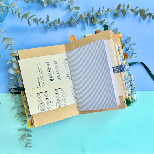 Open journal showing decorated pages with recycled and vintage papers