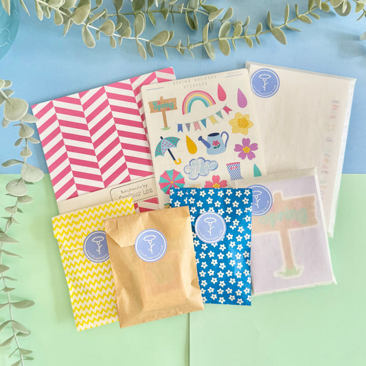 Soft pastel journaling kit contents laid out for spring-themed crafting