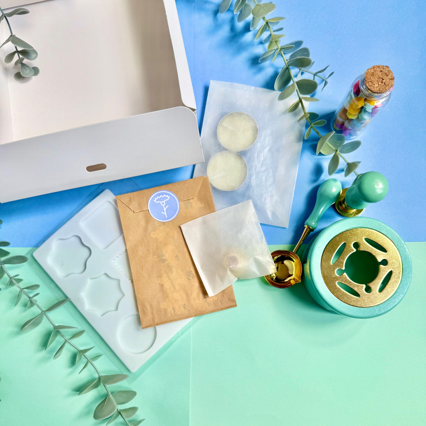Flat lay of wax seal tools and packaging with vintage-style