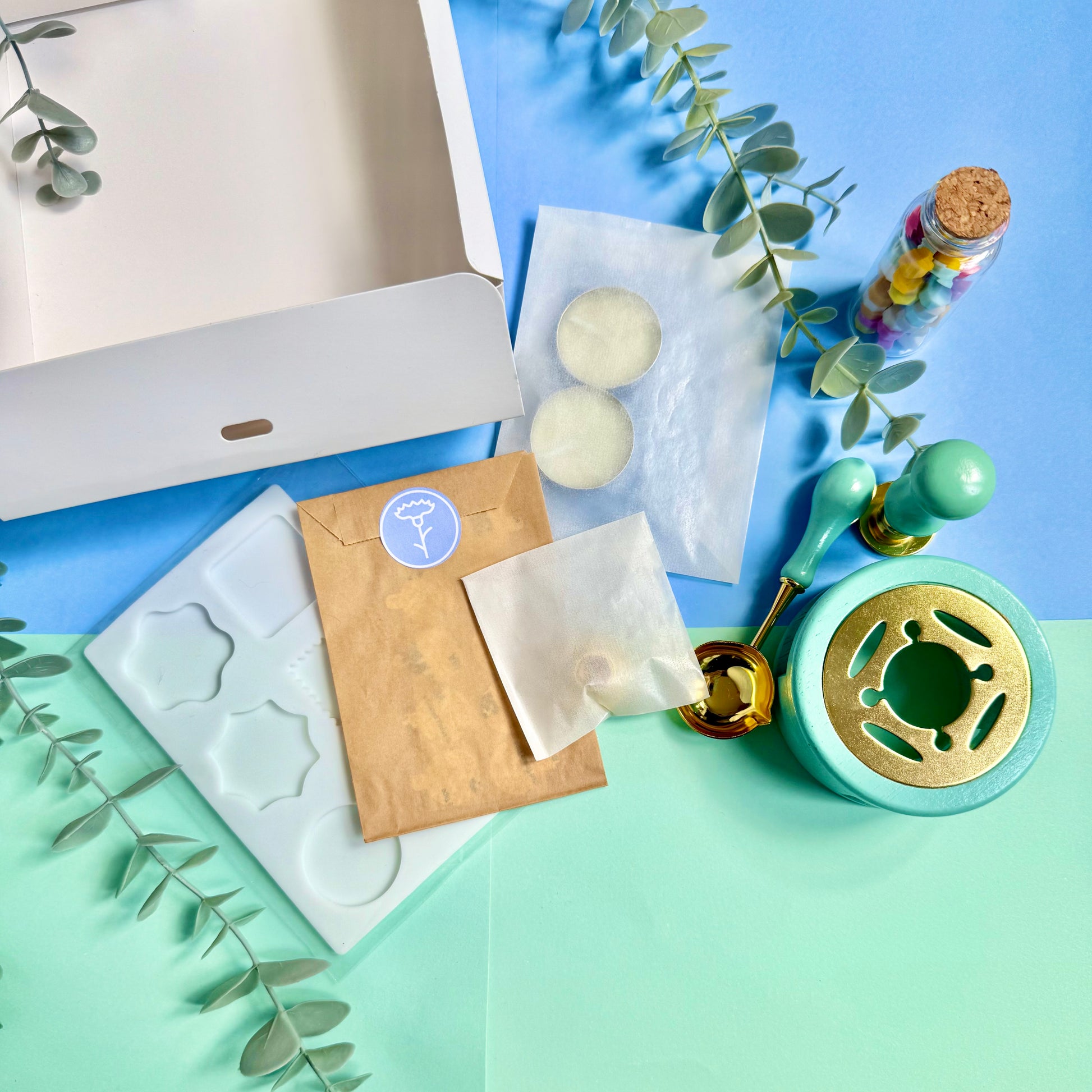 Flat lay of wax seal tools and packaging with vintage-style