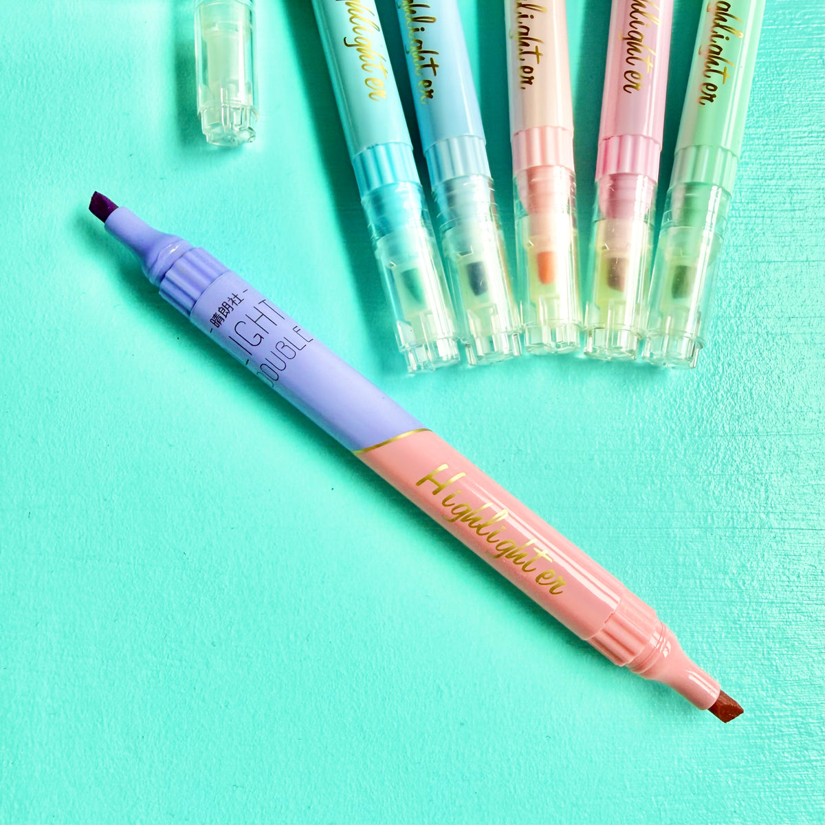 Pastel double-ended highlighter uncapped, showing lilac & coral chisel tip
