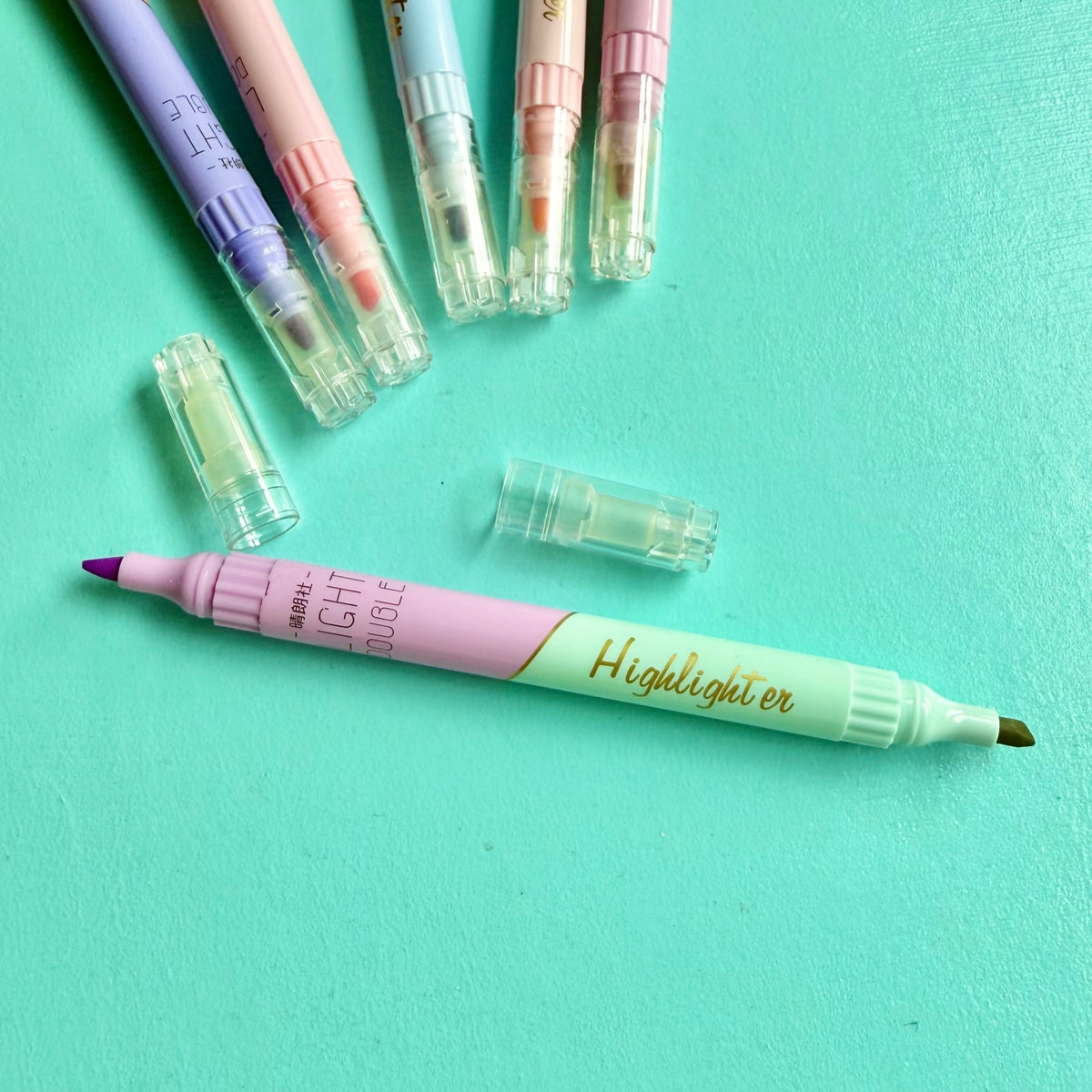 Pastel double-ended highlighter uncapped, showing lilac & green chisel tip