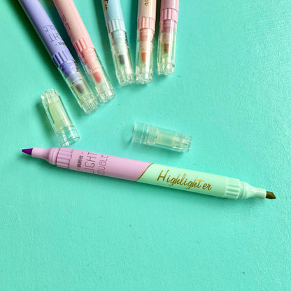 Pastel double-ended highlighter uncapped, showing lilac & green chisel tip